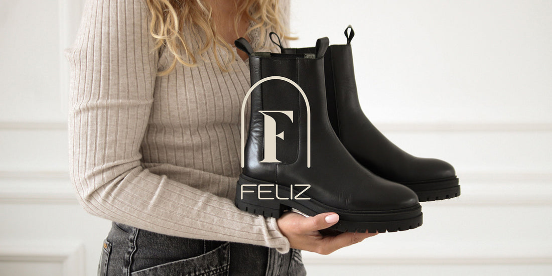 Girl holding black leather boots from Feliz Shoes